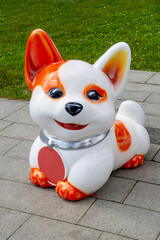 Plastic beautiful figure of a white fox cub on a clear sunny day. Children's games, sports, hobbies.
