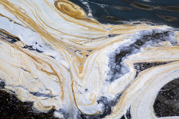 A background of white and blue foam on the surface of the water. Texture backgrounds for wallpaper...