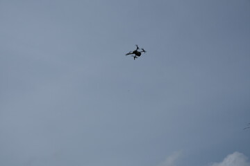 Drone Flying in Clear Blue Sky