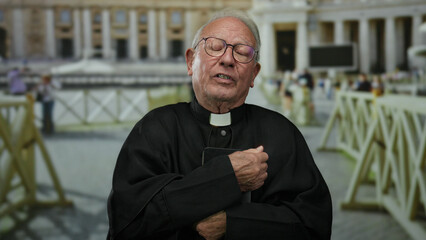 Senior priest man outdoors in vatican city at st. peter's square, dressed in traditional clerical...