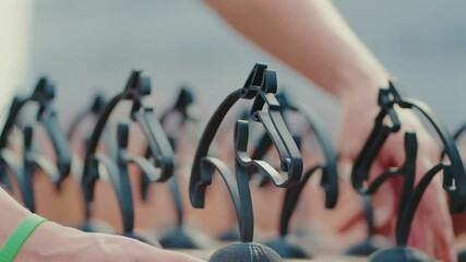 Hands align gleaming black horse trophies on a table for equestrian event. Perfect for award ceremony b-roll or sports event promotions.