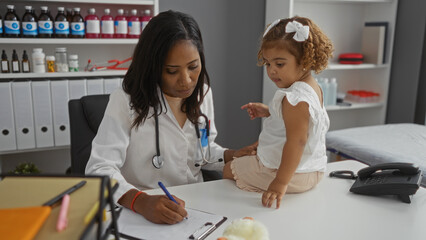 Woman doctor examining child patient in clinic office, focusing on pediatric healthcare...