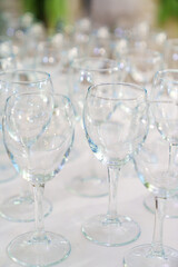 Lots of empty, clean glasses on the table.