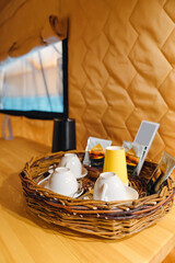 kettle, dishes and tea set on a wicker tray in the glamping room.