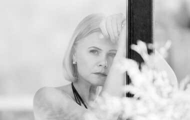 Pensive Woman Behind Window – Thoughtful Sad Portrait in Soft Natural Light