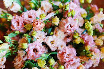 Top view of a basket with a bouquet of Eustoma.