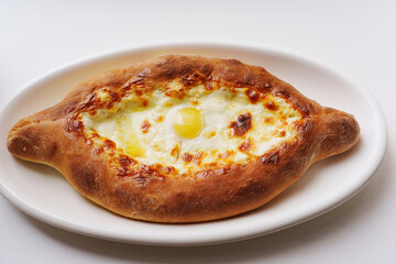 Freshly baked adjarian khachapuri with cheese and egg