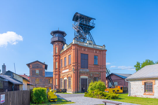 Sevcinsky Mine, located in Brezove Hory near Pribram, showcases its historic architecture and mining equipment under clear blue skies. The site reflects rich mining heritage and industrial history.