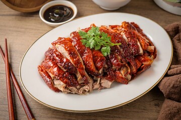 Roasted duck on ceramic plate with sauce, asian food	