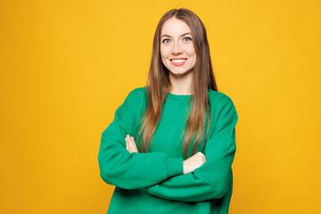 Young smiling happy fun Caucasian woman she wears green sweatshirt casual clothes hold hands...