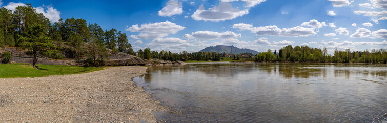 Fototapeta premium View of Love Stone over the Biya River with the town of Turochak on the opposite bank. Concept of serenity, connection, and sacred places in wild Russian nature