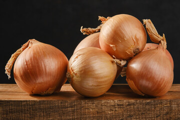 The harvest of onions on wooden table. Shallow depth of field