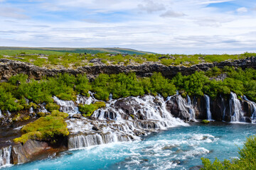 Beautiful Barnafoss and Hraunfossar waterfalls flowing through lush green landscapes in Iceland