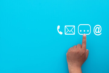 A finger pointing to a chat bubble icon among other contact methods like phone and email.Concept...