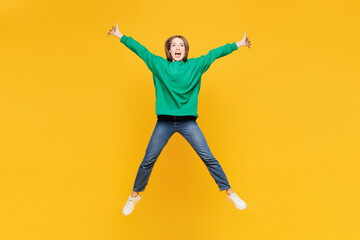 Full body young overjoyed woman she wears green sweatshirt casual clothes jump high with...