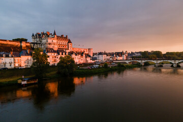 Aerial shot of Amboise castle and bridge over the Loire river at sunset