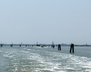 Tranquil venice lagoon canal with distant island horizon and calm waters