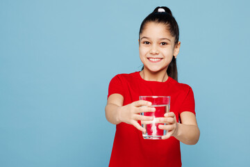 Little kid girl 8-9 years old wears red t-shirt have fun hold give offer glass of water isolated on...