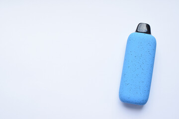 There is one multi-colored electronic cigarette on the light table. A vape with nicotine. Copy space