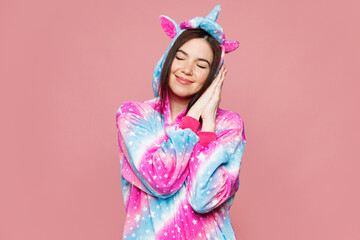Young calm serene woman she wear domestic costume with hoody and animal ears hold hands folded...