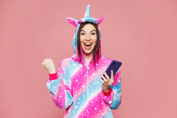 Young woman she wear domestic costume with hoody and animal ears hold in hand use mobile cell phone...