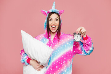 Young shocked amazed happy impressed woman wear domestic costume with hoody hold pillow lying in...