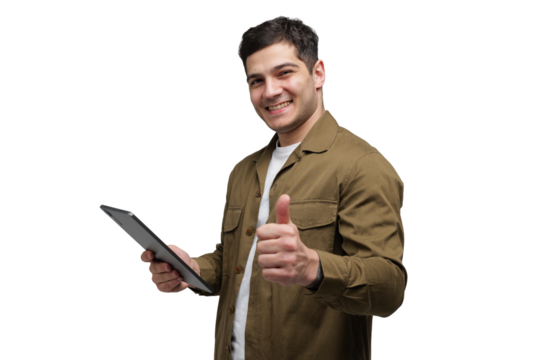 Enthusiastic young man gives a thumbs up while holding a tablet, showcasing positivity and engagement in technology today
