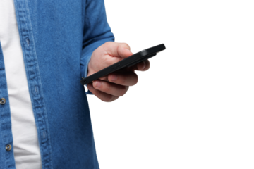 Hand of a person holding a smartphone while wearing a blue denim shirt in a neutral setting