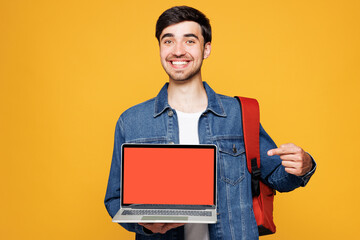Young boy IT student he wear jeans casual clothes backpack bag hold use work point on blank screen...