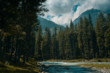 Kumrat valley deep jungle and river and snowy mountains