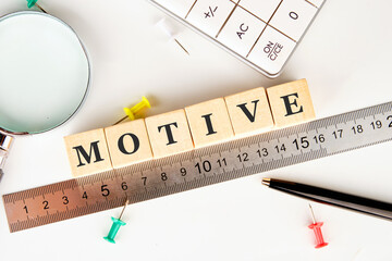 The concept word MOTIVE is assembled from wooden cubes. business motivational concept