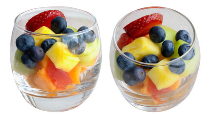 close up of a colorful fruit salad in small glass bowl isolated on white, side view, top view.
