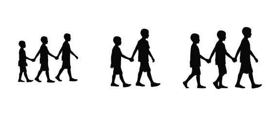 Children holding hands while walking together in a playful and friendly manner during a sunny day