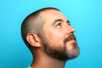 Obraz premium Concept graphic design art of style for aging men. A midlife gentleman with grace and sophistication. Blue solid background. Modish men's crew cut haircut - midlife white man with hair.