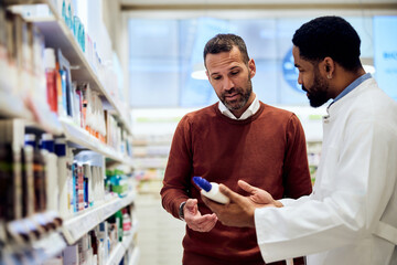 Customer and Pharmacist Discussing a Product in a Pharmacy Aisle