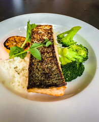 Salmon with green cauliflower and rice served on a plate