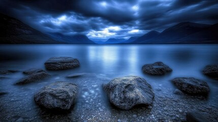 Tranquil lake scene with rocks at twilight.