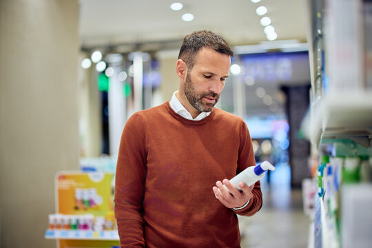 Man Shopping for Personal Care Products in a Well-Lit Retail Store