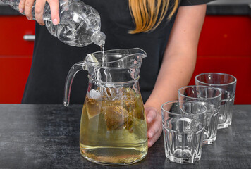 A cold refreshing drink for hot days, a glass jug filled with iced tea
