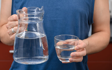 Man holding a jug of water, drinking water during training