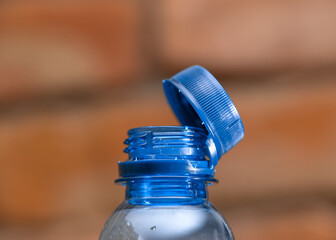 Close-up of a permanently attached plastic bottle cap