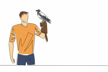 Single one line drawing hooded crow perched on hand of man. Weekend at the zoo. Trying to take pictures with the birds. The bird lover. Man Holding Bird. Continuous line design graphic illustration