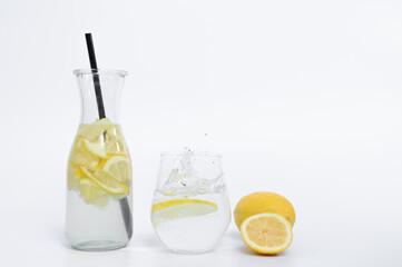 Refreshing lemon water to drink in a transparent glass