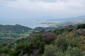 Obraz premium View of Lake Bafa from Latmos Caria hiking trail in spring. View of Lake Bafa from Latmos mountain. Latmos Caria trekking trail. Muğla, Türkiye.