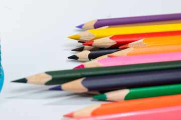 Brightly colored pencils are neatly arranged in a row, perfect for art projects and learning. Ideal...