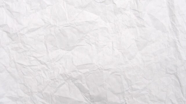 Wrinkled Paper Texture: A close-up shot highlights the intricate textures and shadows on a sheet of crumpled paper, revealing the unique character and subtle variations of its surface.