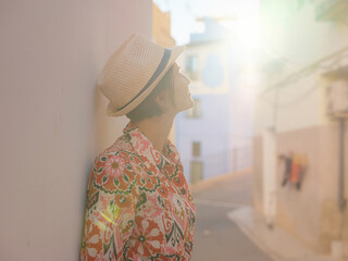 Woman in dress strolls through colorful streets of Spanish coastal town of La Vila Joiosa or Villajoyosa. sunny winter atmosphere highlights charm of Mediterranean architecture and quiet seaside life