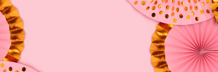 Banner with frame made of paper fans on a pink background.