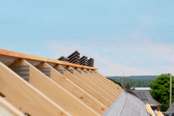 Construction elements made of timber roof frame showing wood beams and metal connectors on ...