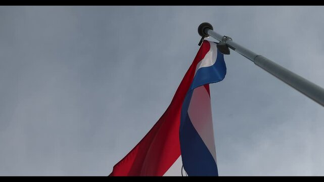 The National Flag of Paraguay flutters in the wind. Great for news. Close-up. The flag of Paraguay against the blue sky. 4K video.